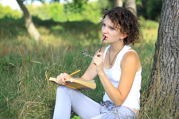 istock Young girl reading a book 153745168