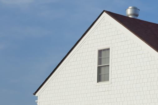 Close-up of house construction showing cedar siding.