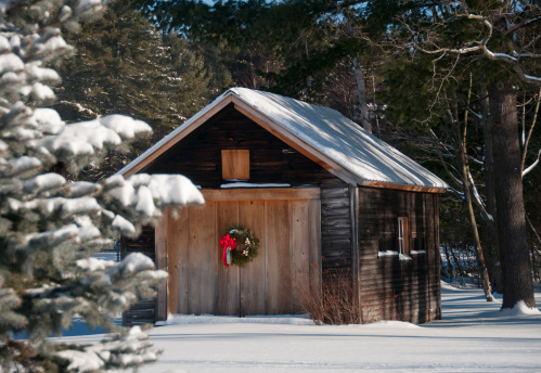 Country barn with holiday wreath in after fresh snowfall. You can see other versions in my portfolio. Thanks Karen