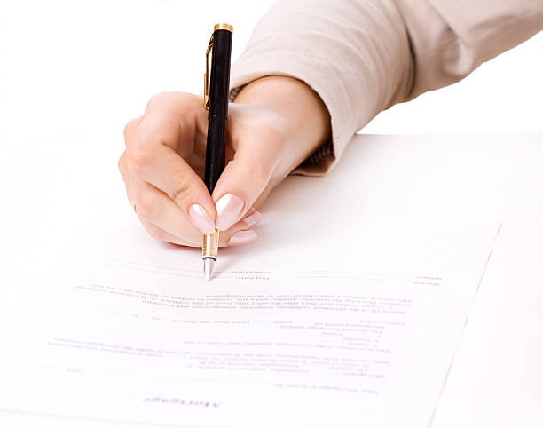 istock female hand signing a contract, mortgage 153745740