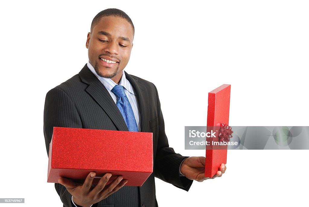 African american business man opening a christmas gift box This is an image of a business man opening a christmas gift box. Adult Stock Photo