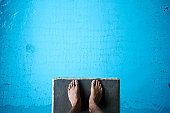 istock Aerial view of man's feet on diving board on blue 153746212