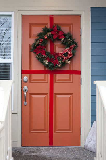 istock Orange Door with a Wreath and Ribbon 153747535