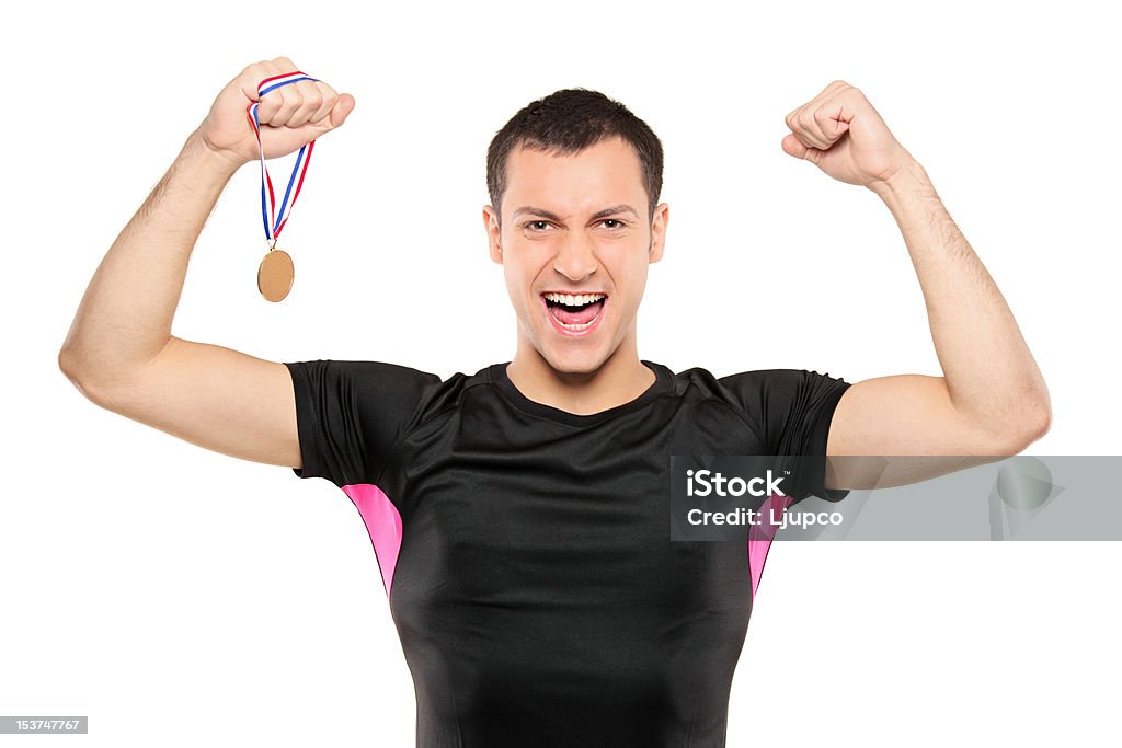 Young happy sportsman holding a gold medal Young happy sportsman holding a gold medal isolated on white background Leotard Stock Photo