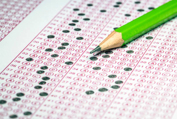 istock Exams quiz test paper with pencil drawing selected choice on answer sheets at school 1537478346