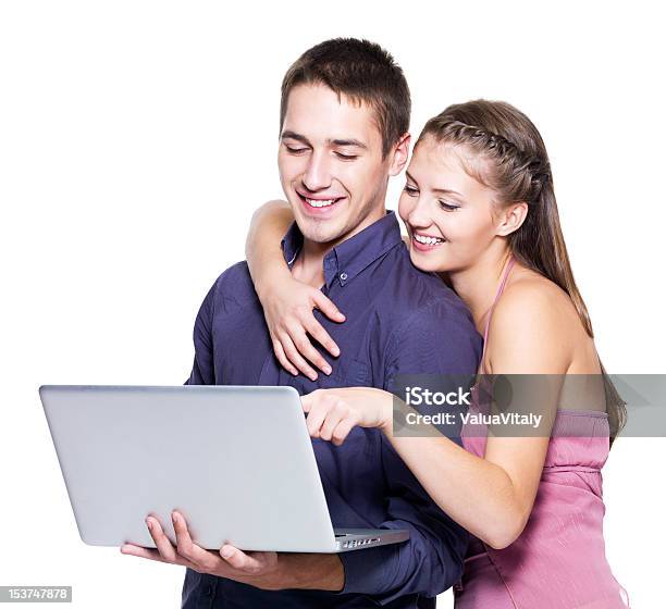 Young Beautiful Smiling Couple Looking At Laptop Stock Photo - Download Image Now - 20-29 Years, Adult, Adults Only