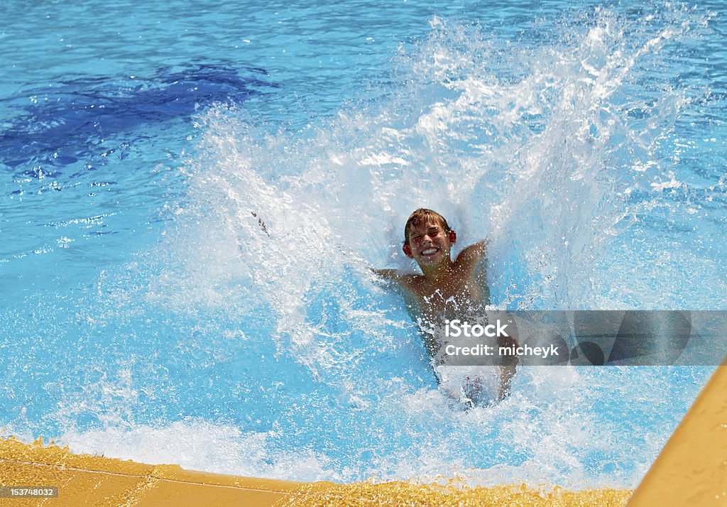 Fun in water Young boy falls into the water with a waterslide Splashing Stock Photo