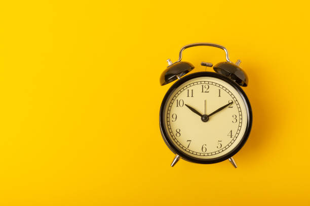 istock alarm clock on a bright yellow background.Top view.Close-up.Copy space. 1537485135