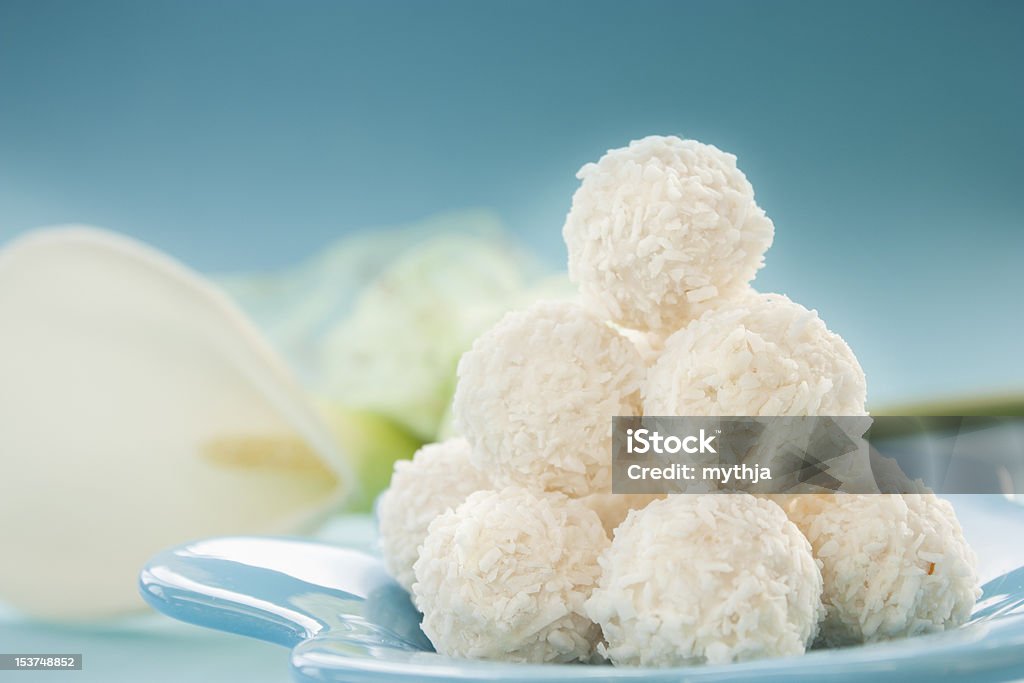 Coconut cookies Arrangement of coconut cookies on blue background. Panellets Stock Photo