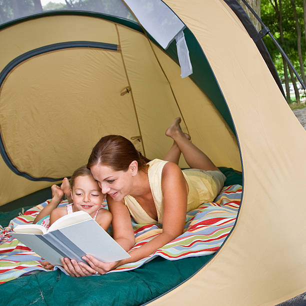 istock Mother Reading to Daughter in Tent 153750054