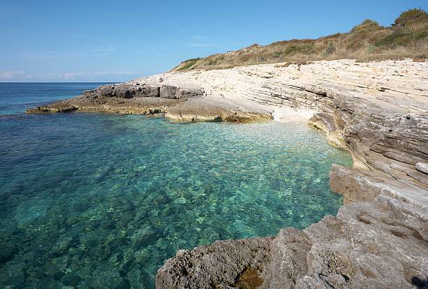 istock Empty rocky beach with clear turquoise water bay 153750347
