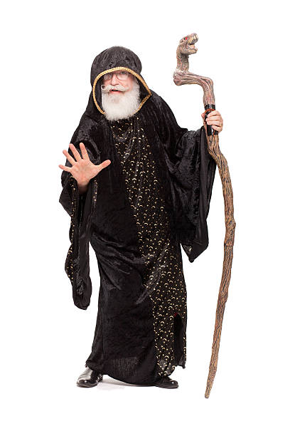 A man dressed as a wizard stands against a white background Merlin the wizard merlin the wizard stock pictures, royalty-free photos & images