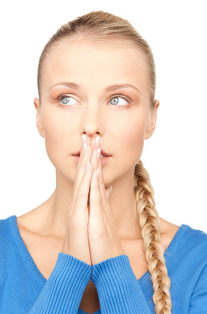Businesswoman holding her fingers crossed against white background