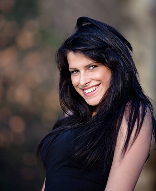 Young woman smiling in to the camera.