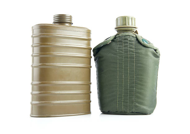 Old military flask on white background. Army water bottle and flask isolated on white. Military soldier green canteen of the army during the war. Vintage water bottle and retro bowler.