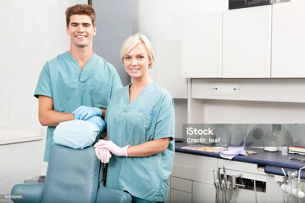 Dental Team Portrait of a confident male and female dentists smiling at dental clinic 30-34 Years Stock Photo