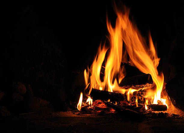 Log fire Log fire on black background warming up stock pictures, royalty-free photos & images