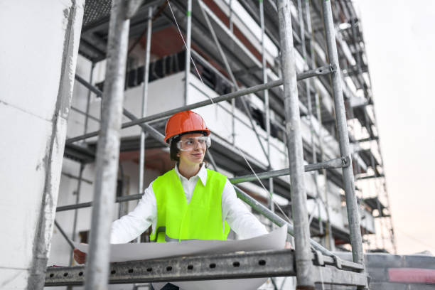 istock Female Civil Engineer Examining Plans On Construction Site 1537531042