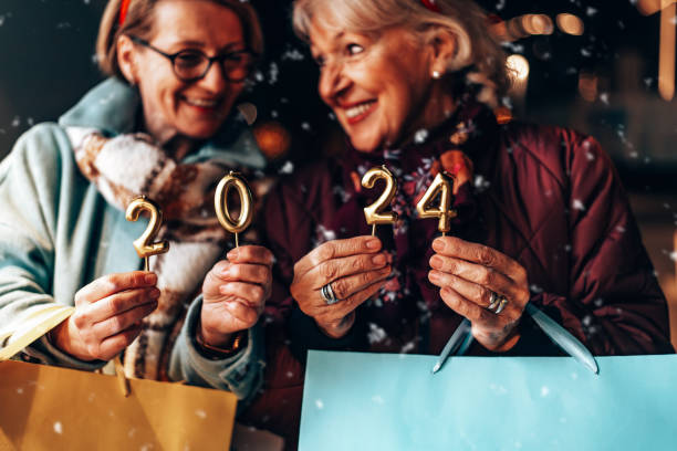 Senior friends enjoying together in New Year Eve stock photo