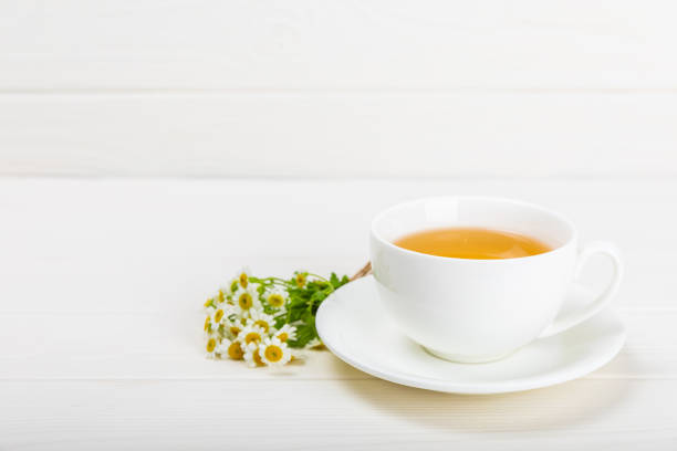istock Chamomile tea in a  cup on  texture background. Natural hour with chamomile flowers. Herbal tea. Immunity tea.Natural healer concept. Healthy detox drink.Close up. Place for text. 1537532783