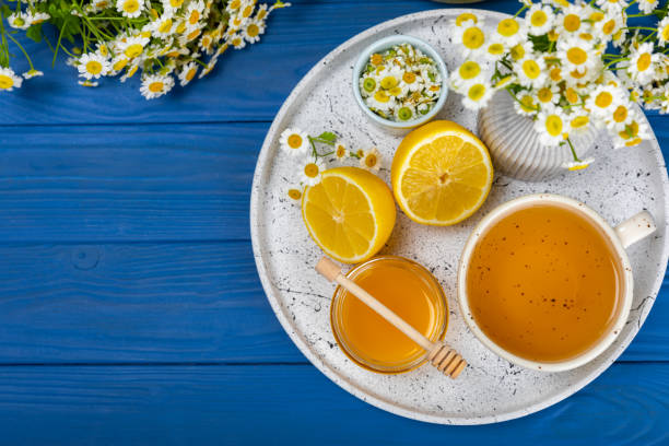 istock Chamomile tea in a  cup on  texture background. Natural hour with chamomile flowers. Herbal tea. Immunity tea.Natural healer concept. Healthy detox drink.Close up. Place for text. 1537533734