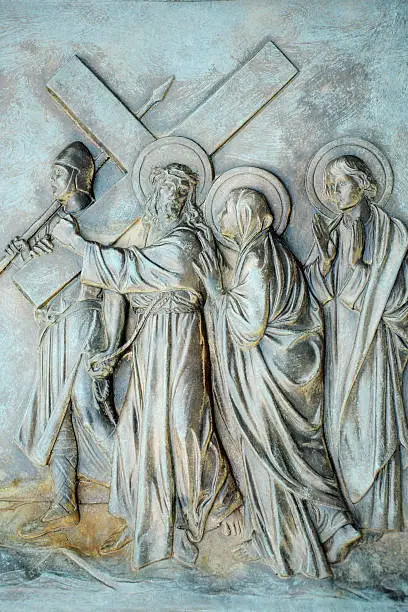 A stone relief depicting the 4th Station of the Cross where the condemned Jesus meets His mother as he carries the cross towards Calvery.