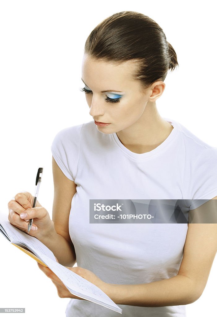 Girl escribe para escribir, en libros - Foto de stock de Actividad móvil general libre de derechos