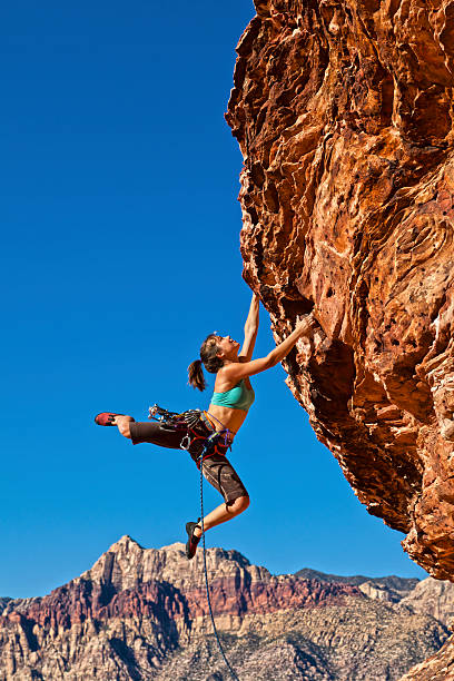 istock Female rock climber clinging to a cliff. 153753946