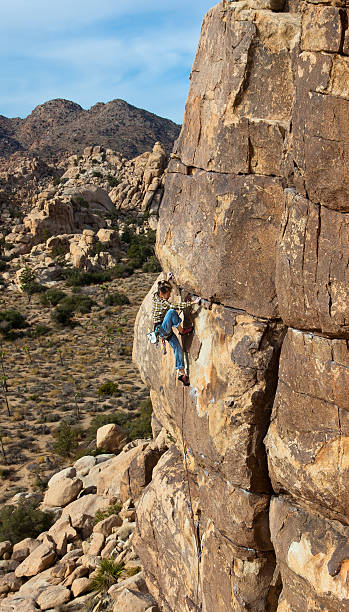 istock Female climber clinging to a cliff. 153754074
