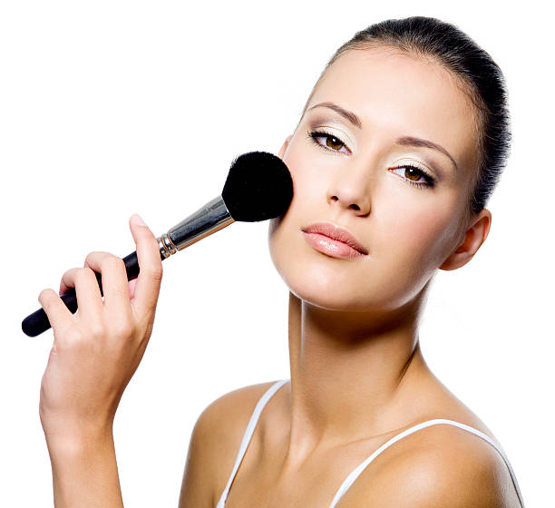 istock woman applying powder on cheek with brush 153754084