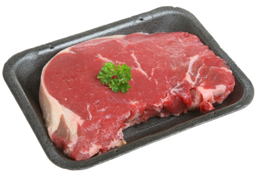 Thick sirloin steak in styrofoam packaging tray.