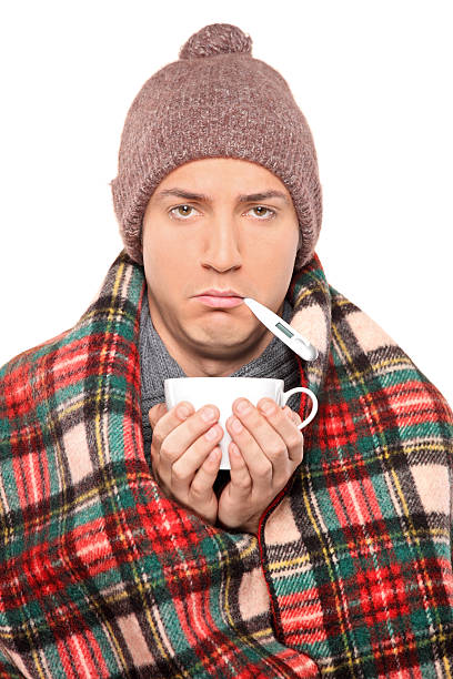 istock Ill man covered with blanket holding a tea cup 153754630