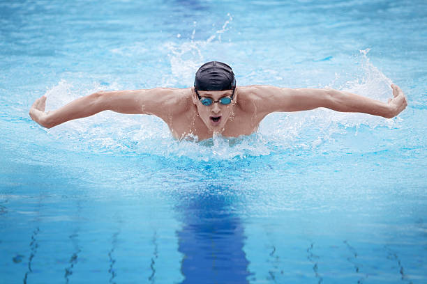 Photo of an athlete swimmer performing the butterfly stroke stock photo