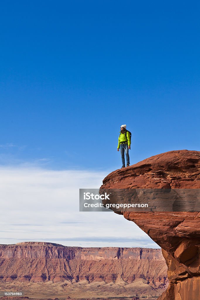 Hiker on the summit. Hiker on the summit of a sandstone spire in Canyonlands National Park. Achievement Stock Photo