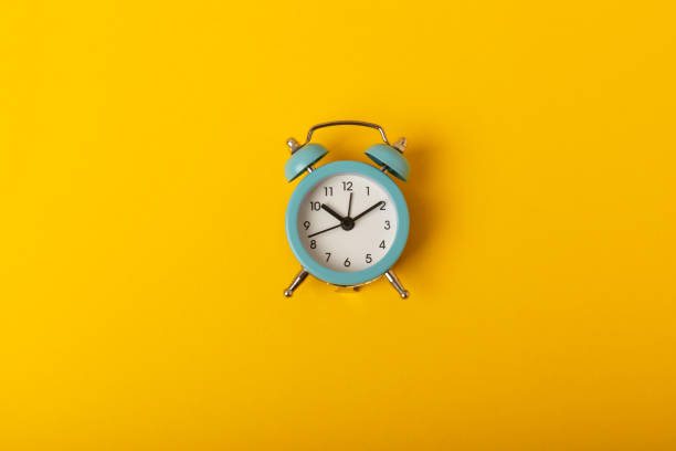 istock alarm clock on a bright yellow background.Top view.Close-up.Copy space. 1537553572