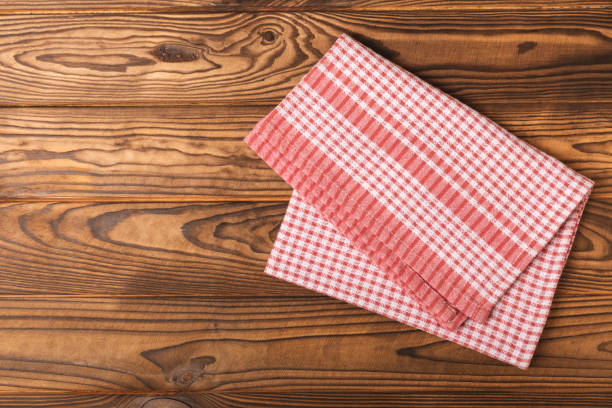 istock Kitchen towels on a marble background. New kitchen cotton towels on the kitchen table. Red checkered picnic napkin. Home textiles. Place for text. copy space. 1537554714