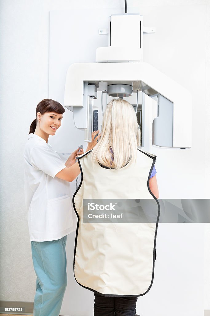 Dental X-Ray Young female orthodontist taking a panoramic digital xray of a patient`s teeth Medical X-ray Stock Photo
