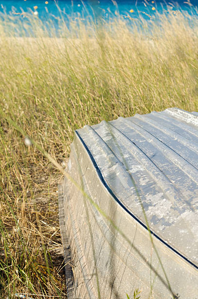 Aluminium dingy boat lying on seashore stock photo