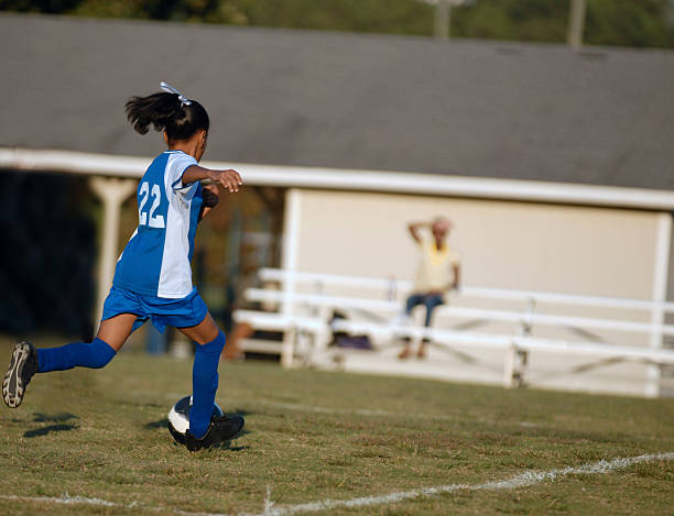 istock girl chasing soccer ball 153757806