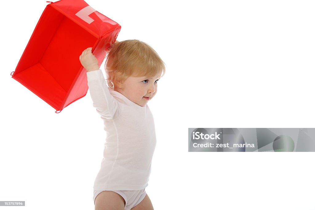 Baby throwing red box isolated on white 1 year old baby throwing red box isolated on white 12-23 Months Stock Photo