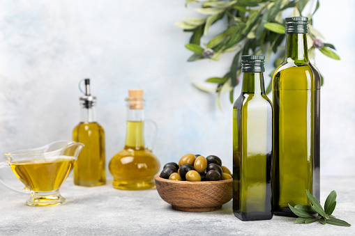 Olive oil bottles and heart shape bowl as heart healthy food  on white background