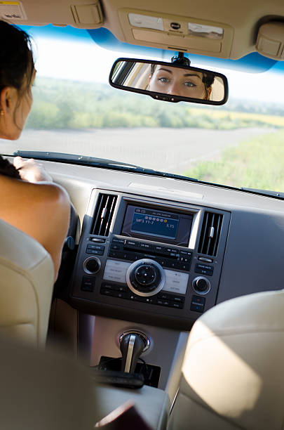 istock Woman driver looking in her rear view mirror 153758447