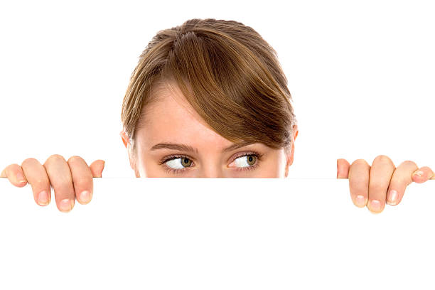 istock Woman peeps out from behind the blank board 153758616