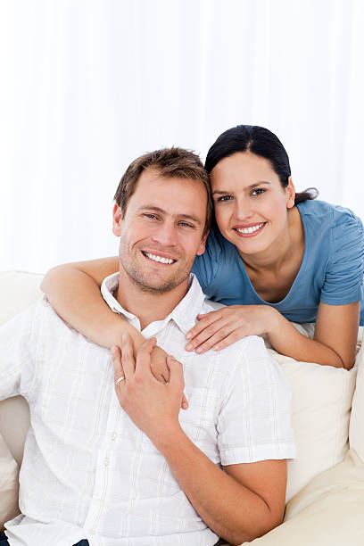 istock Woman hugging her boyfriend on the sofa 153759173