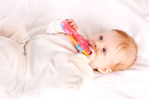 istock Baby playing with rubber toy. 153759179