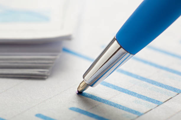 istock Checking the value of securities. Pen, share listing and checking financial chart. Concept of banking, financial report and financial audit. 1537605775
