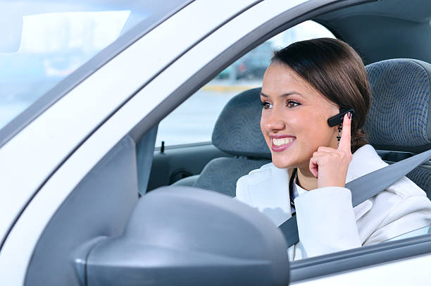 beautiful woman is safely talking phone in a car stock photo