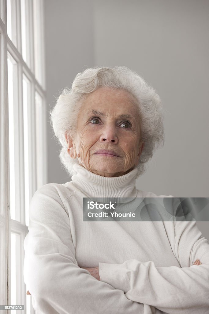 senior woman smiling old woman beside window Adult Stock Photo