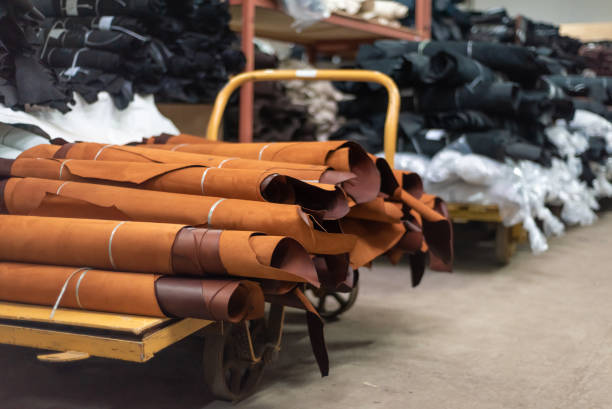 istock Leather production. Rolls of brown leather on a trolley in a warehouse. 1537620330
