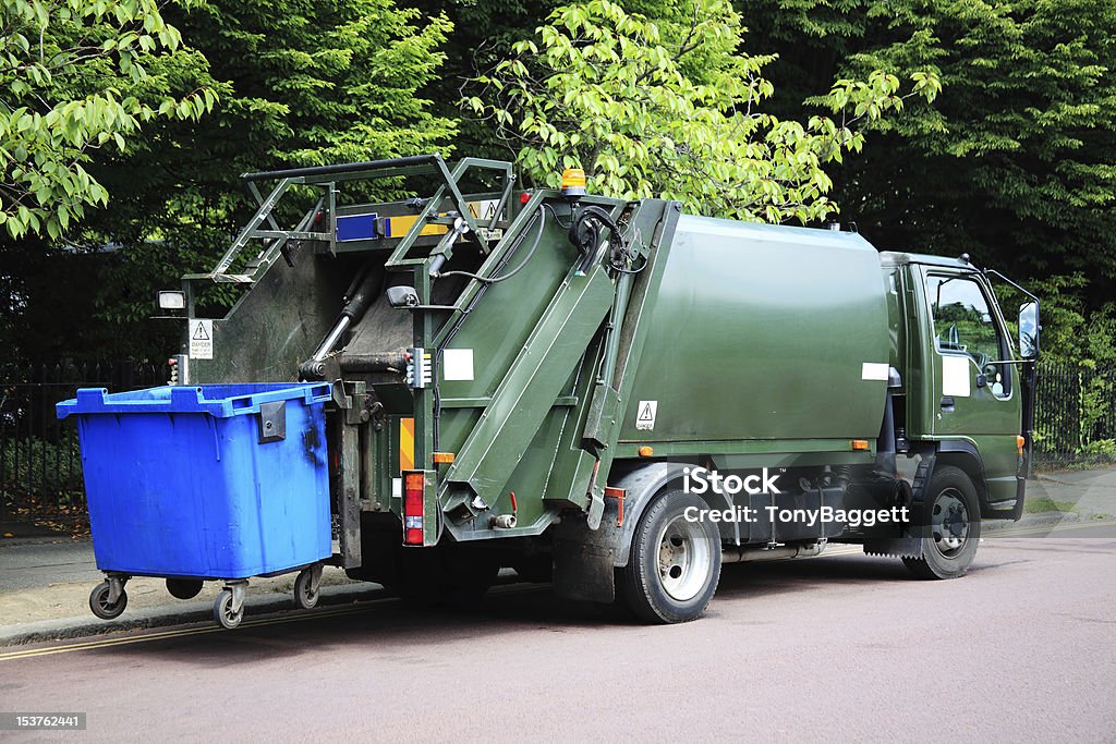 Garbage Truck Green garbage truck with an elevated blue wheelie bin at the rear Garbage Truck Stock Photo